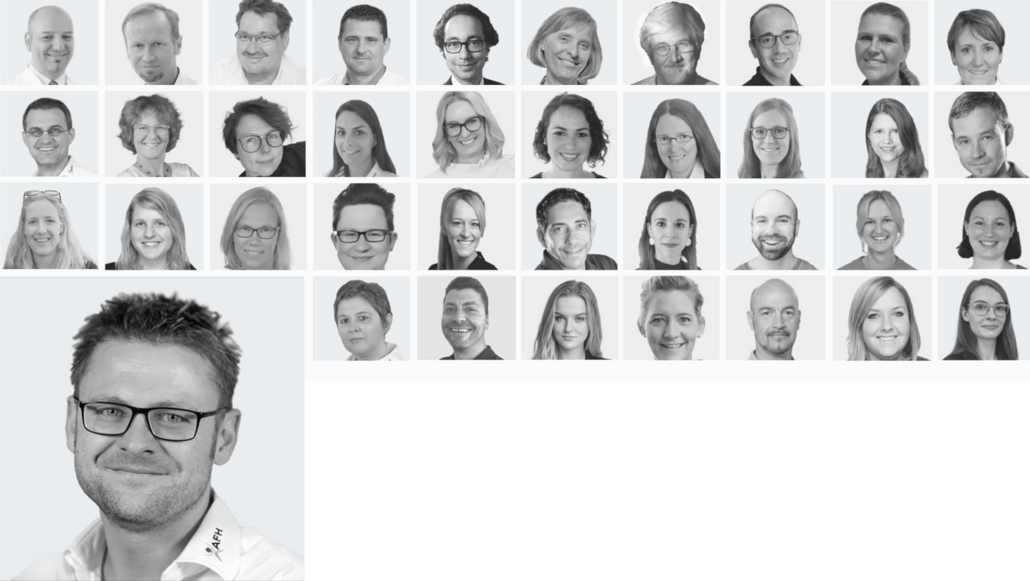 Collage of multiple black‑and‑white headshots of team members, with a larger portrait of a smiling man with glasses in the bottom-left corner.