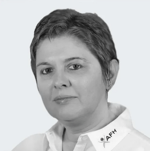Head-and-shoulders portrait of a woman with short hair wearing a white collared shirt and an AFFH pin.